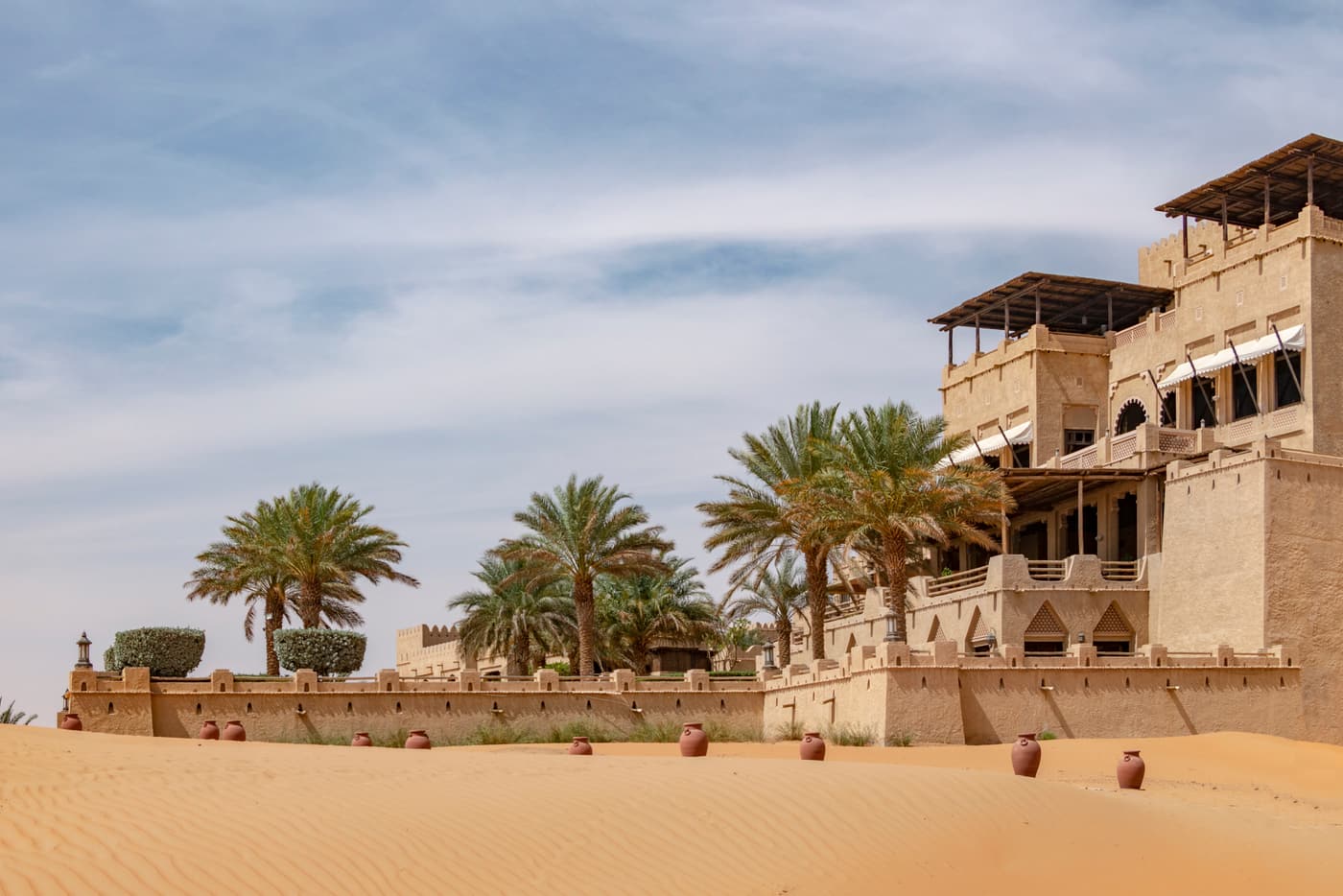 The fort-style buildings of Qasr Al Sarab among palm trees